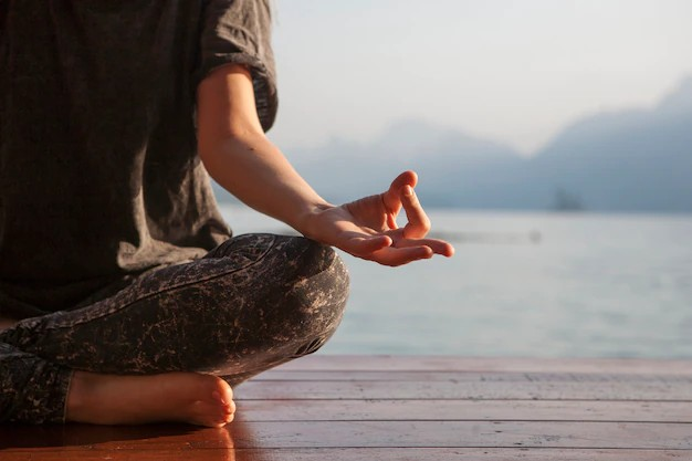 An artistic representation of a girl engaged in meditation and yoga if in the stressful environment. The image portrays the upper half of a girl's body, with her eyes closed and a serene expression on her face. 