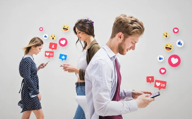 When in stress practice social media detoxing. Two girls and one boy walking together while using their phones, with colorful emoticons flowing in the background.