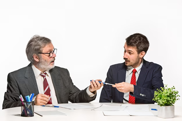 Two businessmen engaged in a conversation, actively sharing their thoughts on a particular subject. Both individuals are depicted with engaged expressions, indicating their involvement in the discussion.