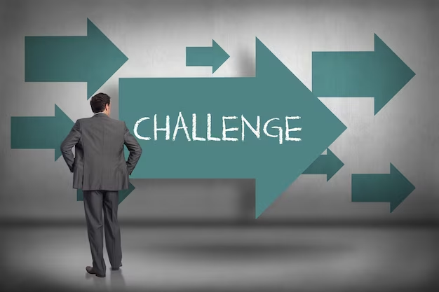 A businessman standing in front of a digital representation that prominently displays the word 'Challenges.'